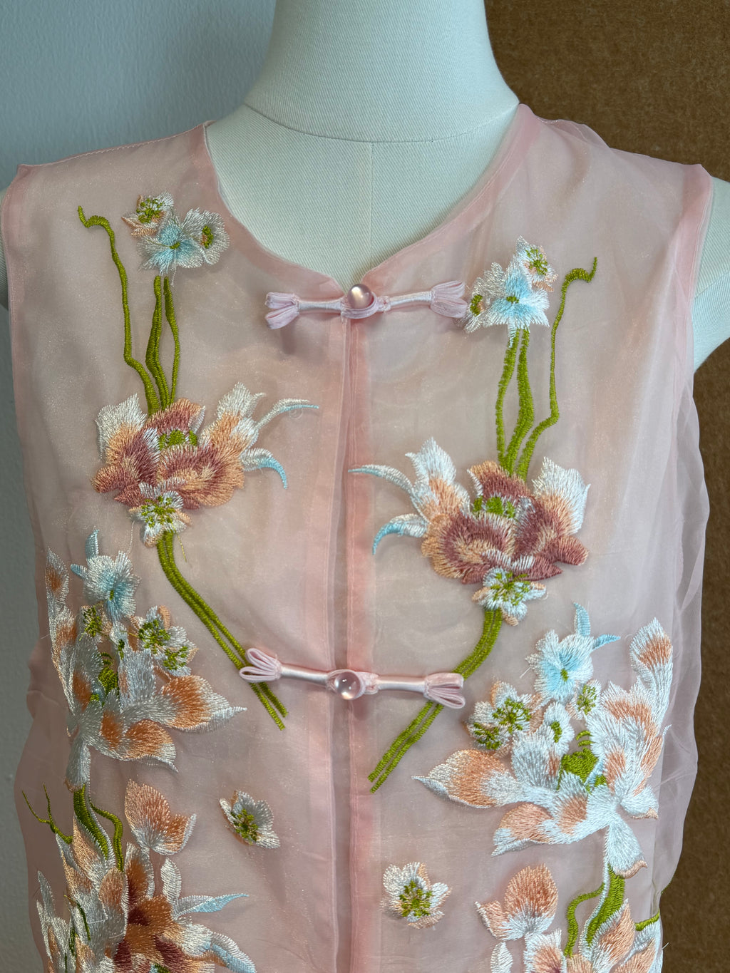 Sleeveless Sheer Organza Top with 3D Raised Floral Embroidery and Satin Loop Buttons | Zoya