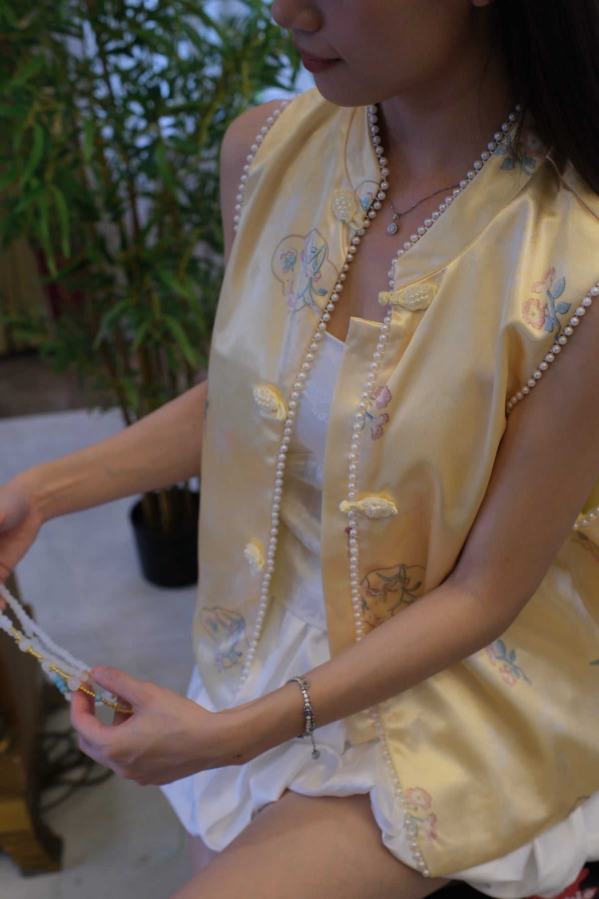 Sleeveless Qipao-Inspired Satin Top with Embroidered Florals, Frog Buttons and Pearl-Beaded Trim | Zia