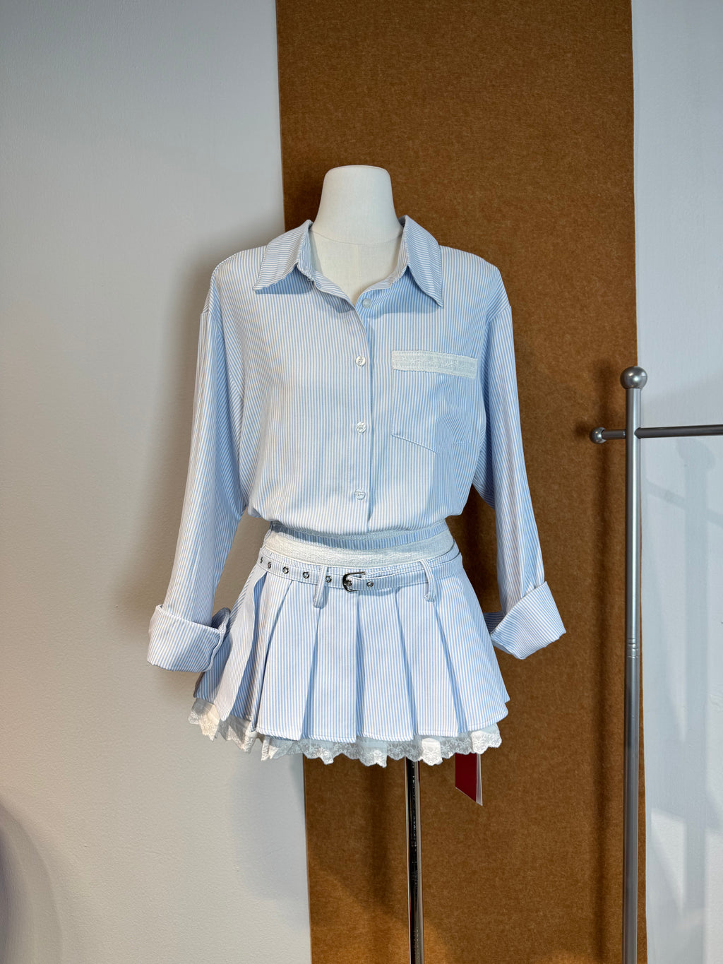 High-Waist Pinstripe Pleated Mini Skirt with Broderie Anglaise Waistband and Grommet Belt | Kallie