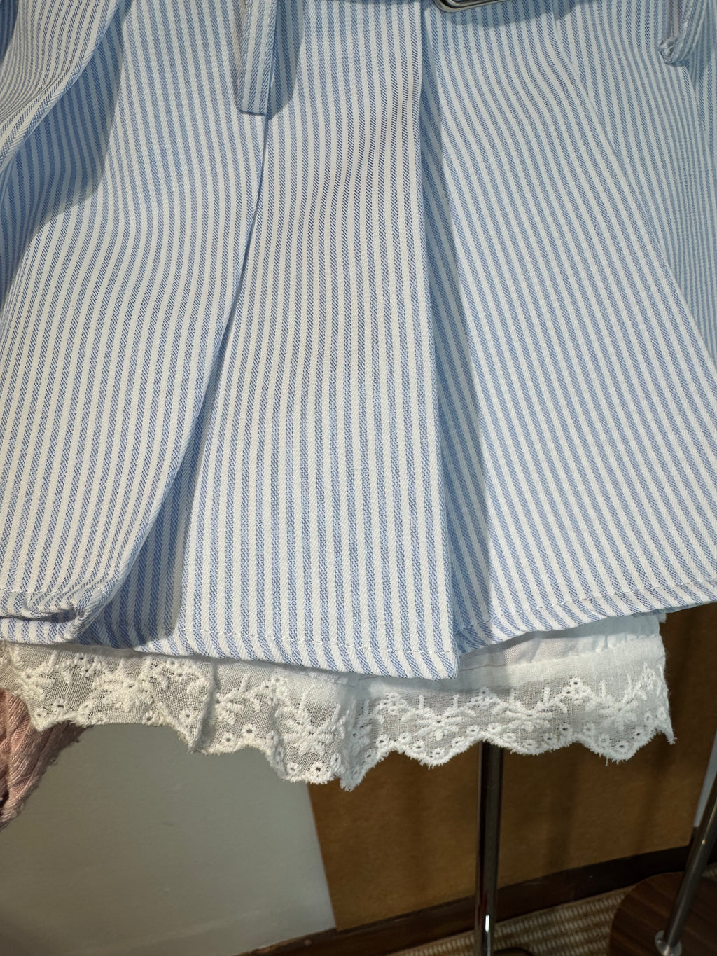 High-Waist Pinstripe Pleated Mini Skirt with Broderie Anglaise Waistband and Grommet Belt | Kallie