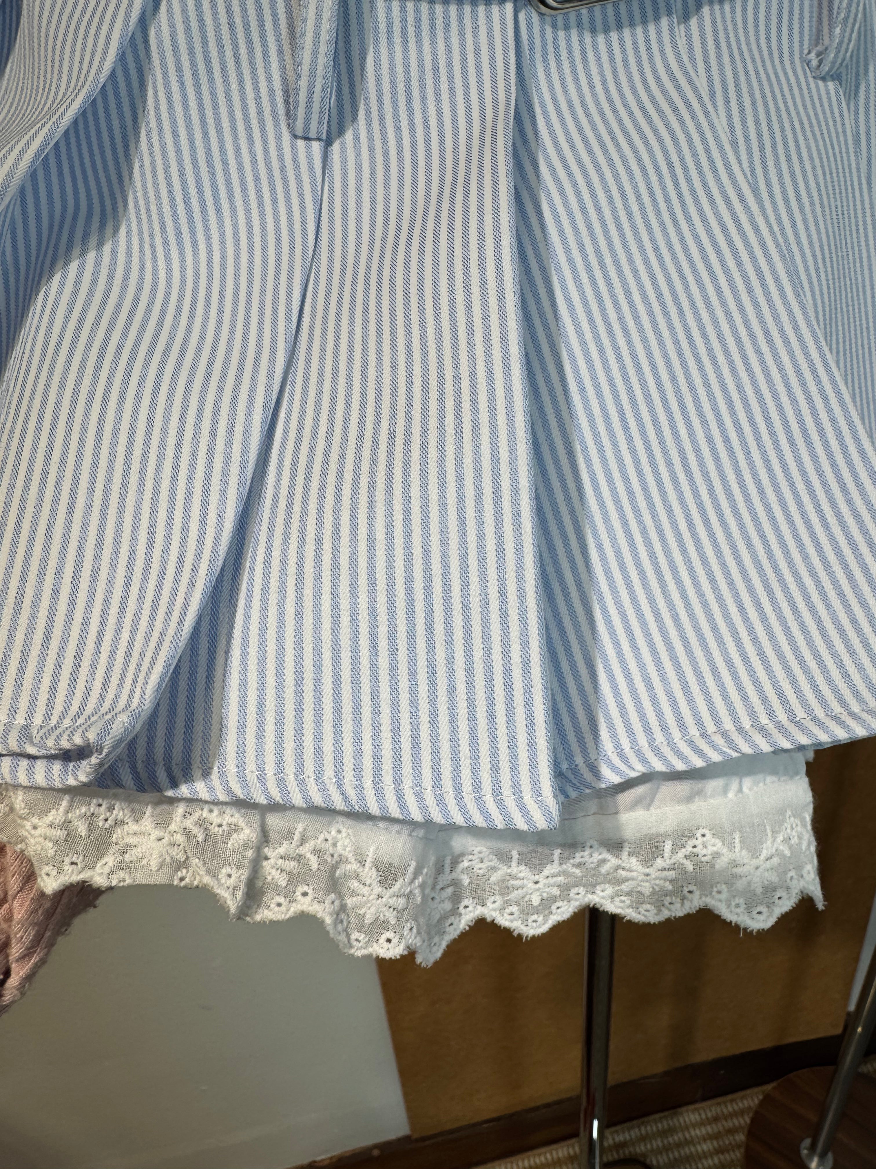 High-Waist Pinstripe Pleated Mini Skirt with Broderie Anglaise Waistband and Grommet Belt | Kallie