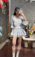High-Waist Pinstripe Pleated Mini Skirt with Broderie Anglaise Waistband and Grommet Belt | Kallie